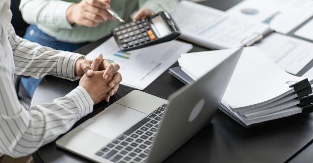 Business-women-checking-annual-financial-statements-of-company Business women checking annual financial statements of company