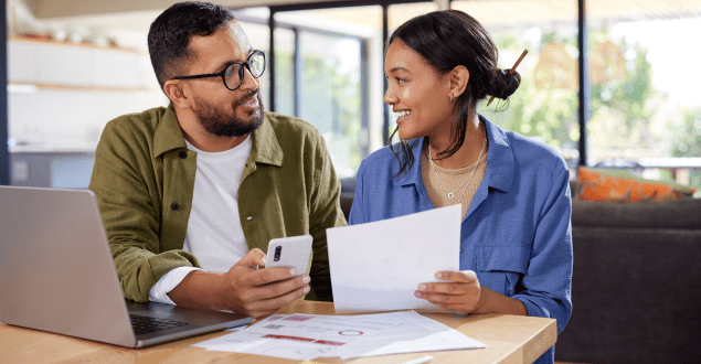 Couple-discussing-home-finance-while-checking-bills Couple discussing home finance while checking bills