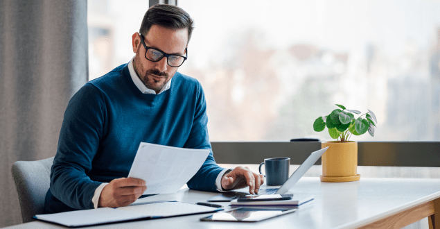 Hardworking-young-adult-businessman-checking-the-company-budget-in-the-files Hardworking young adult businessman, checking the company budget in the files