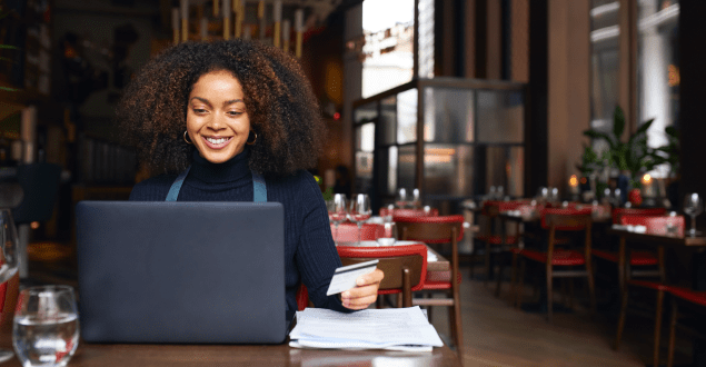 Portrait-of-restaurant-owner-using-laptop Businessperson Opening Envelope With Paycheck