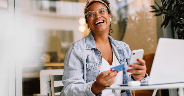 smiling-woman-holding-hone-and-credit-card smiling woman holding hone and credit card