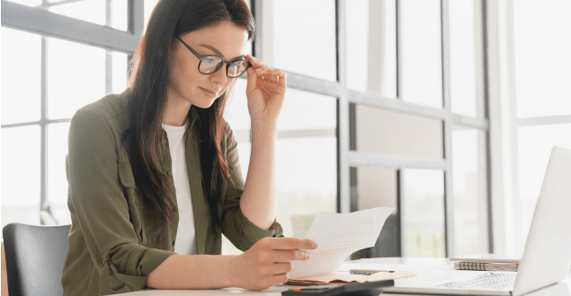 woman-looking-at-bank-document woman looking at bank document