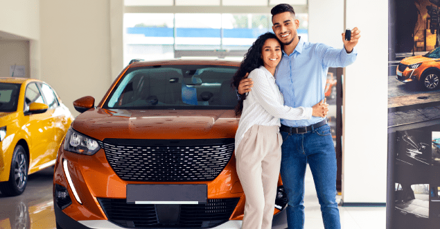 Happy-couple-showing-key,-buying-new-car Happy couple showing key, buying new car