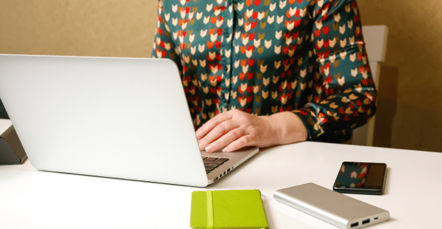 woman-working-on-laptop woman looking at bank document